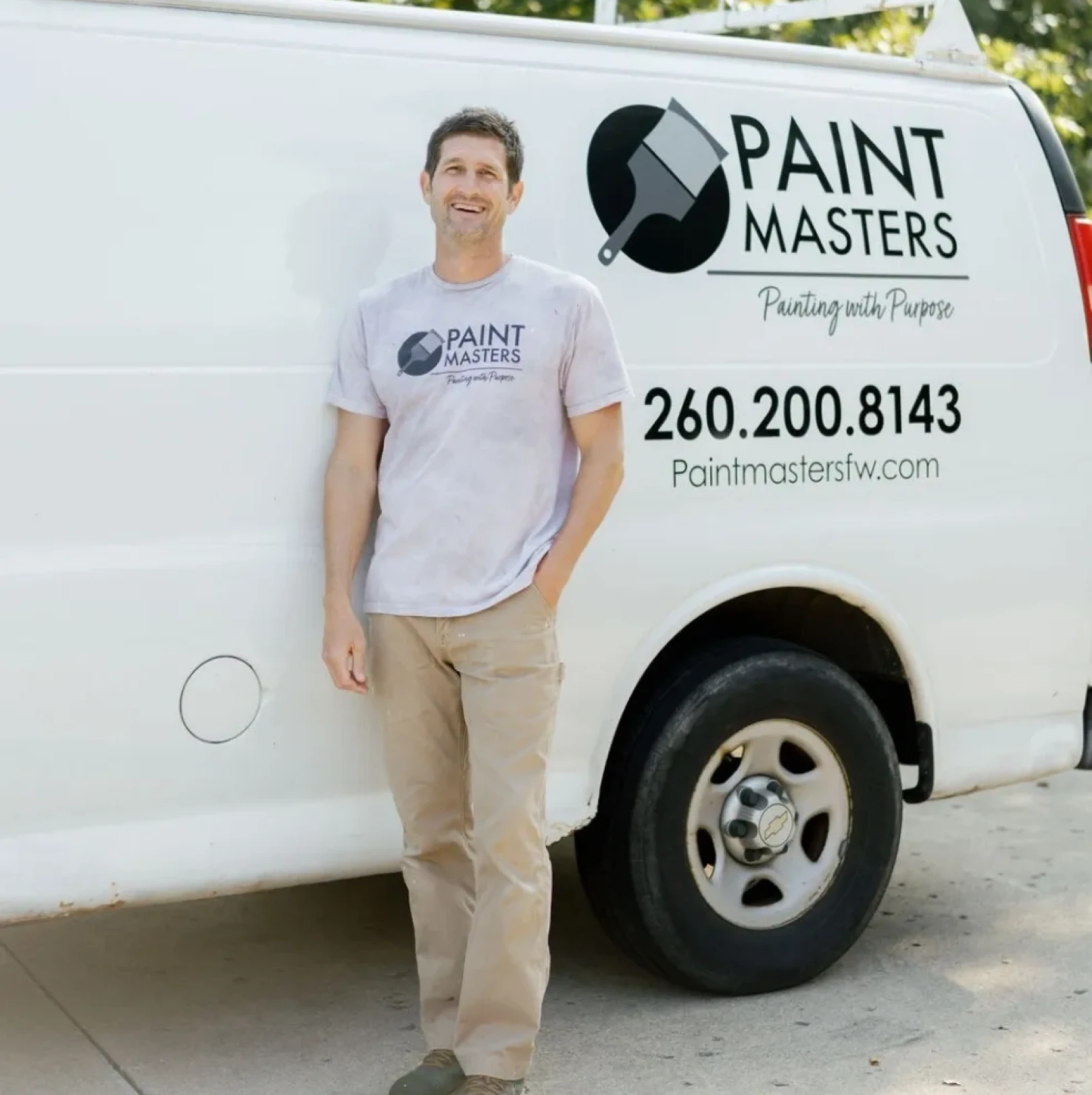 Man leaning on Paint Masters vehicle