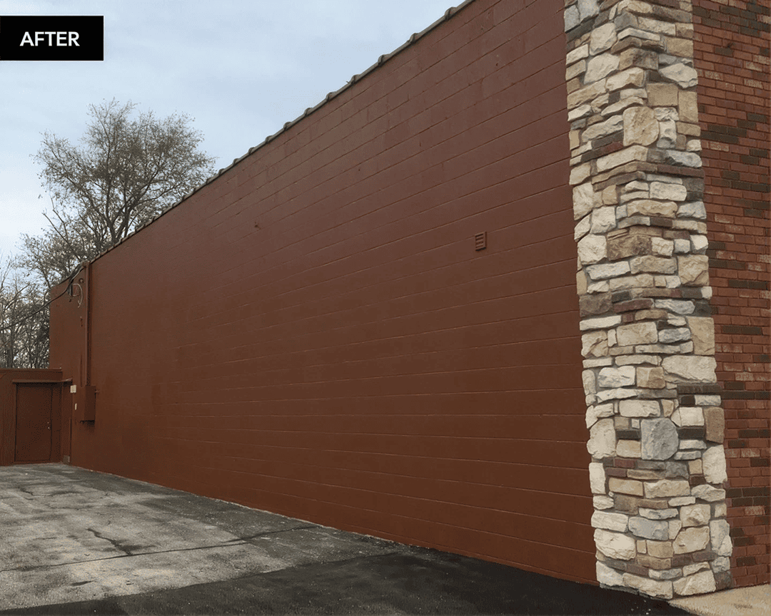 Freshly painted building exterior with stones