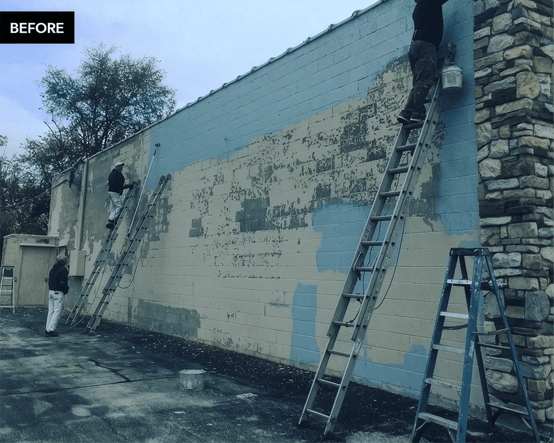 Building wall being prepped with paint